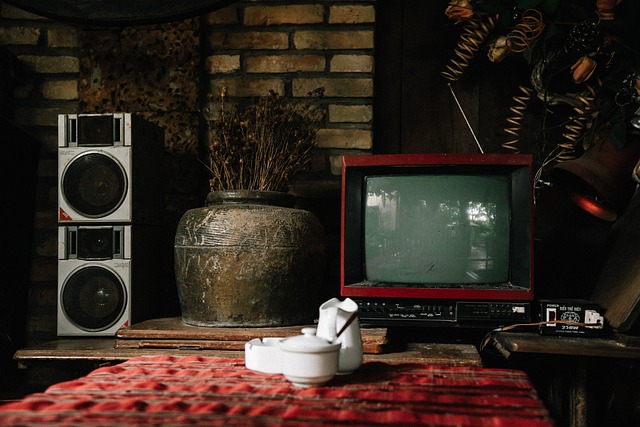 Coffee cup on ottoman in front of vintage TV and stereo